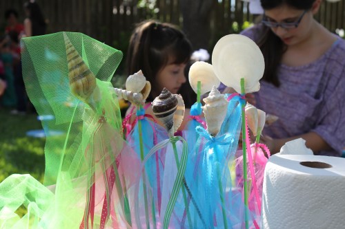 Girls create shell wands.