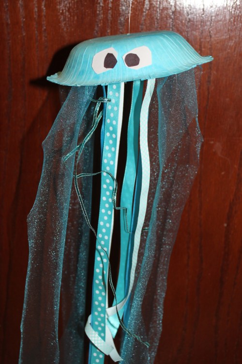 Create floating jellyfish from paper plates and ribbon.